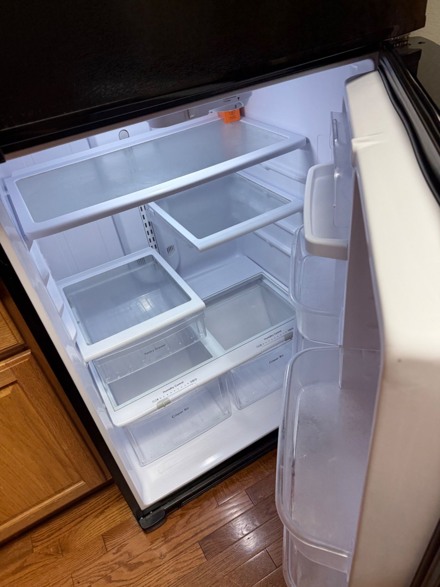 Clean refrigerator interior with wiped shelves and drawers