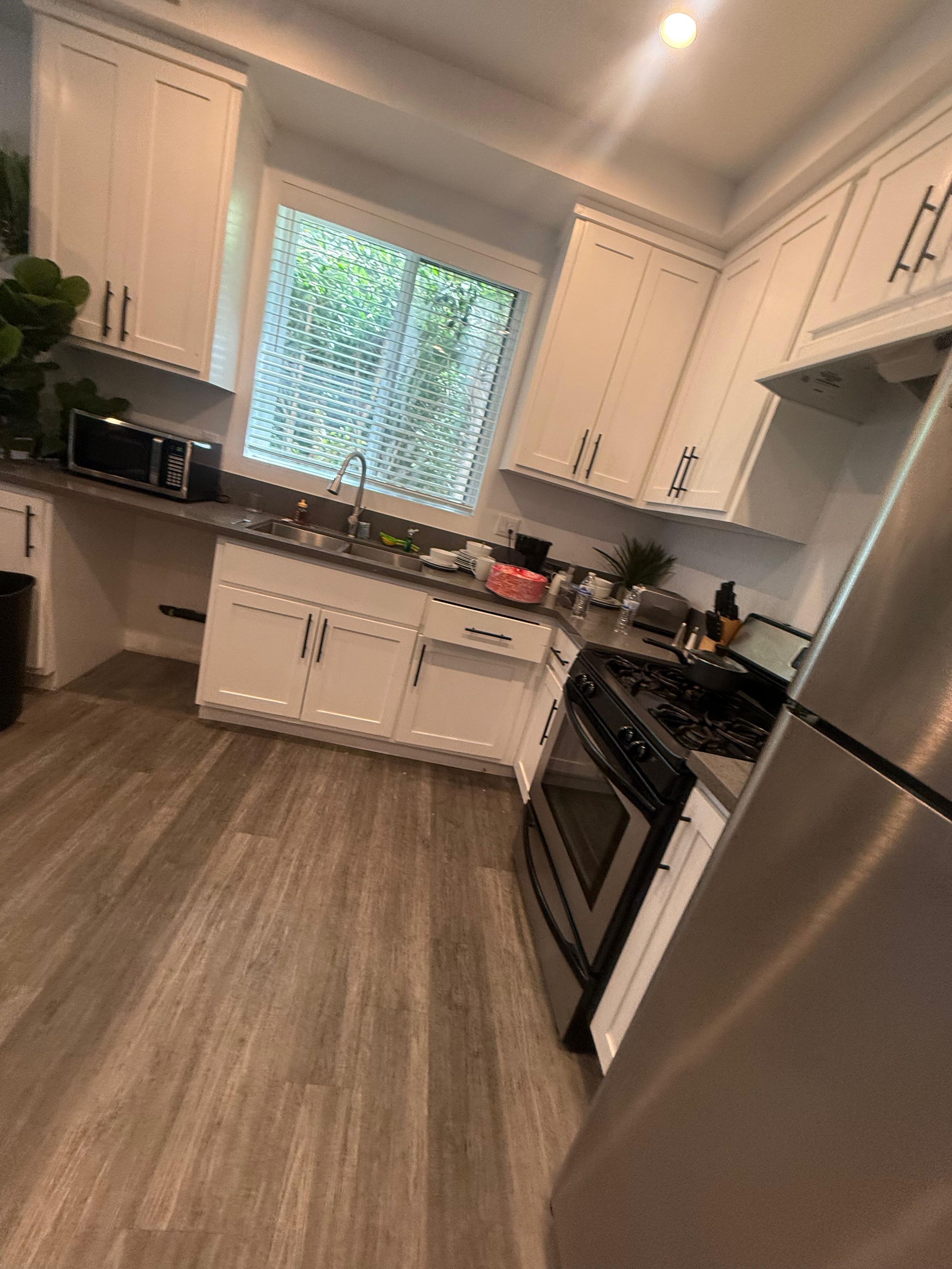 Kitchen with white cabinets and a gas range