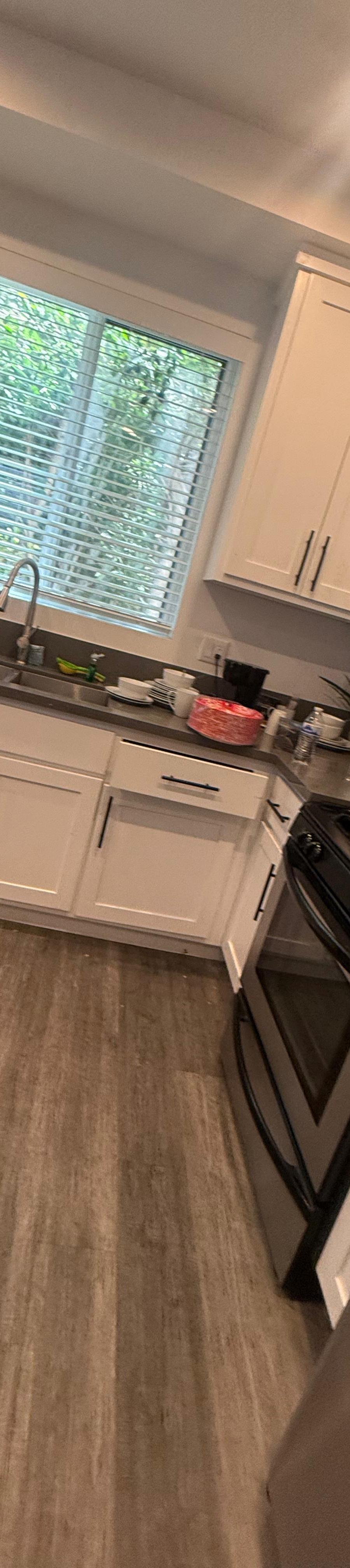 Kitchen with white cabinets and a gas range