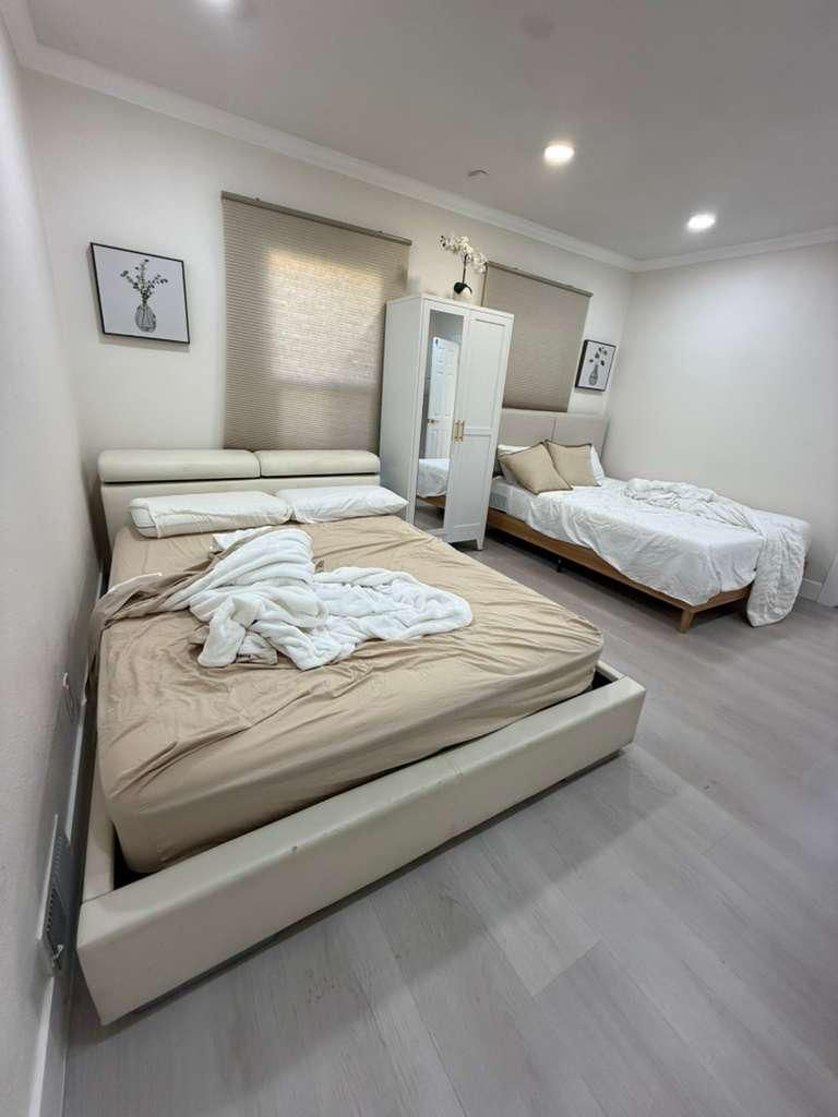 Bedroom before cleaning, with unmade beds