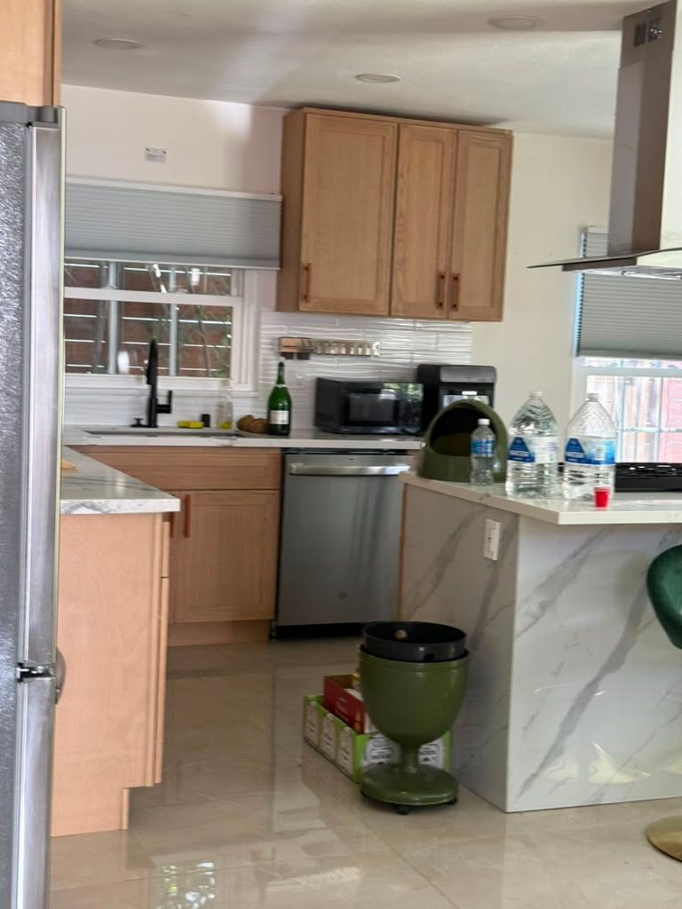 Kitchen with wood cabinets and a marble island