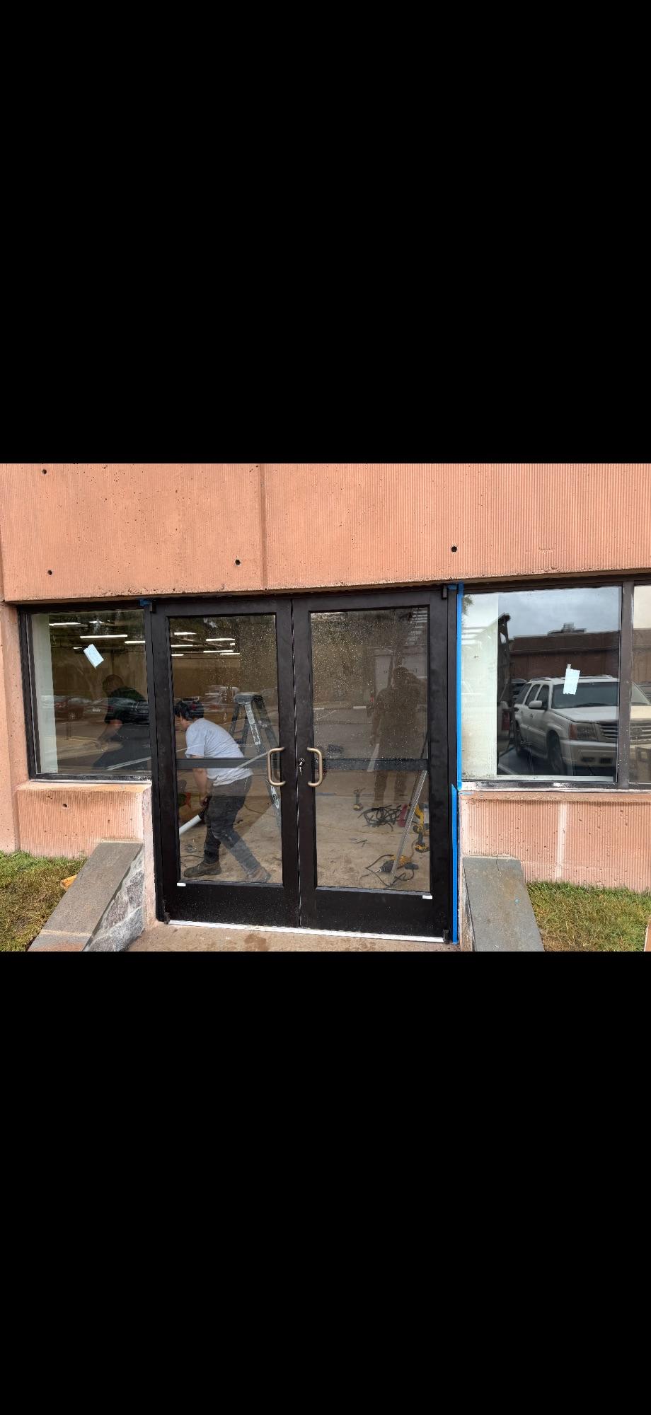 Commercial double glass entrance doors being installed by JCA Glass Door Services