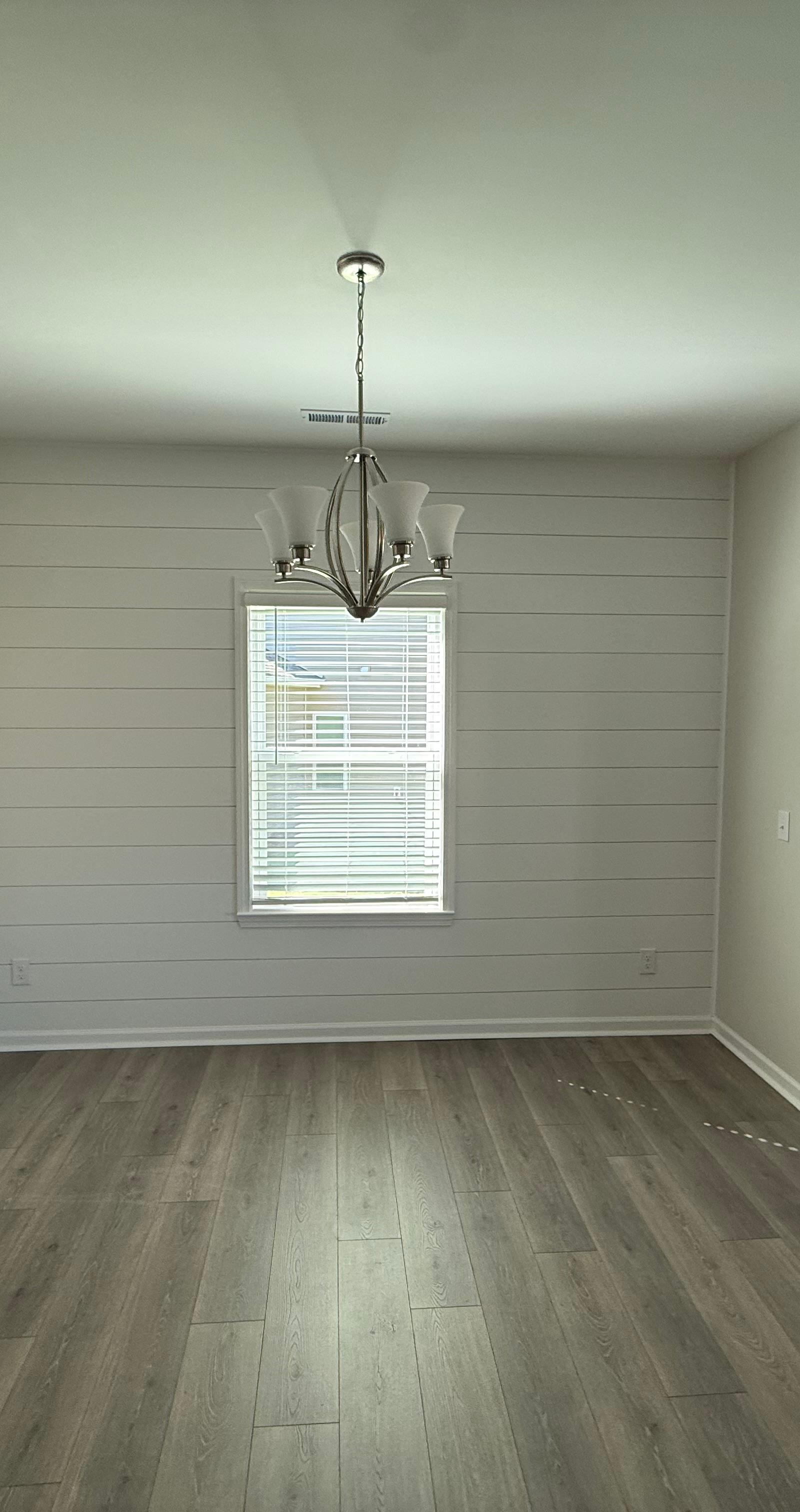 Freshly painted open-plan kitchen with new luxury vinyl plank flooring installed by JD Painting