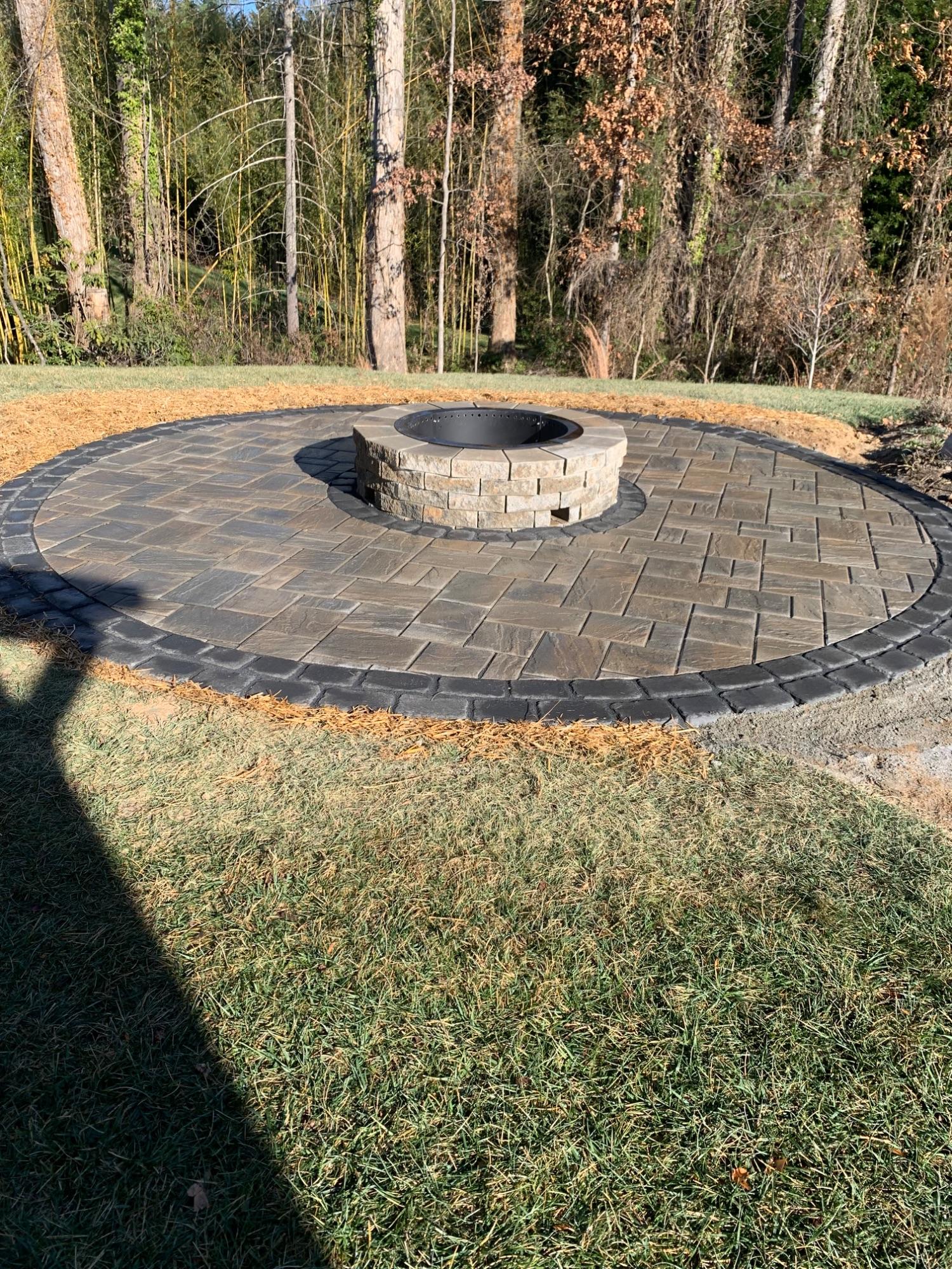 Paver patio and block fire pit with a soldier-course border