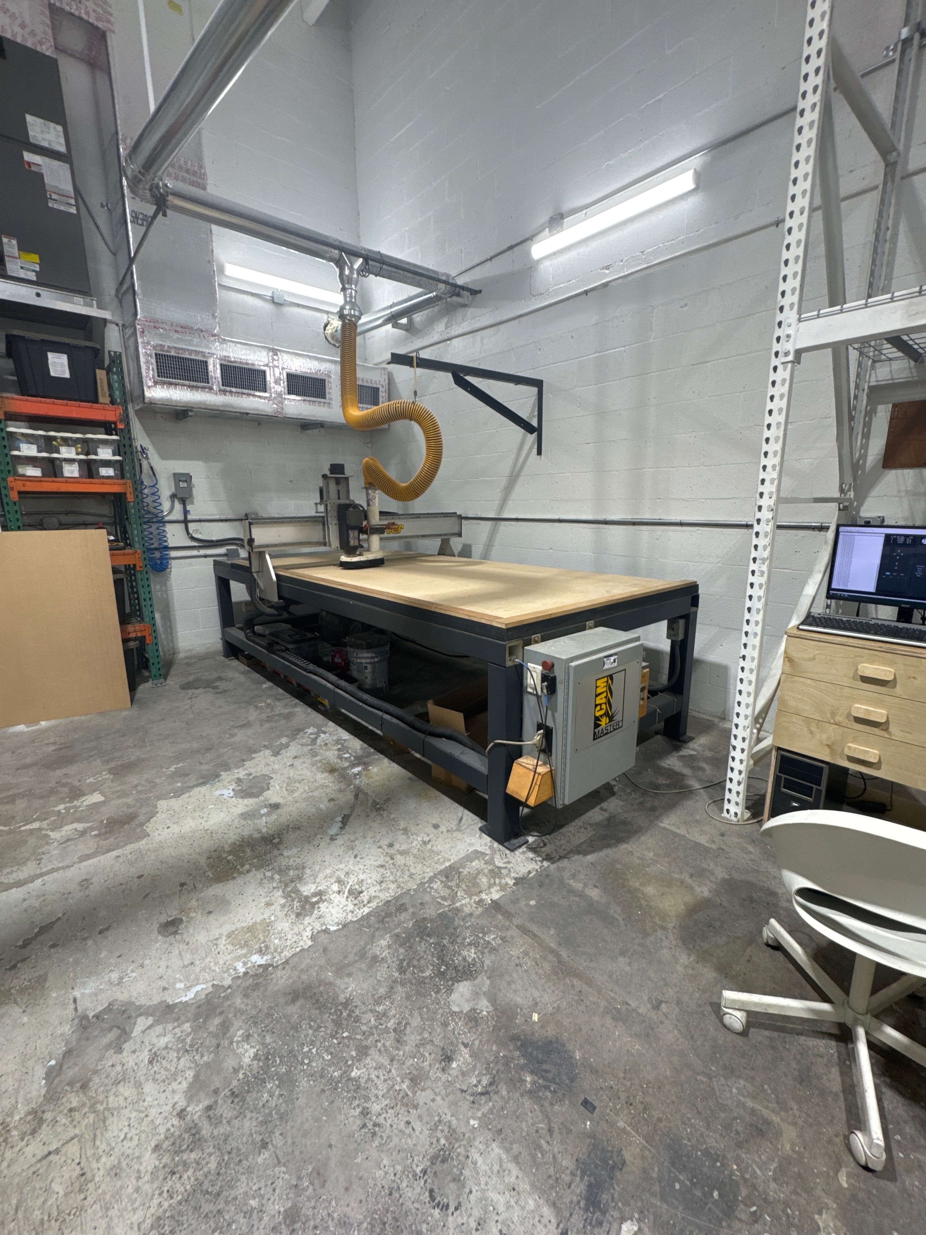 CNC router table with dust extraction in the MK Design US LLC cabinet manufacturing facility