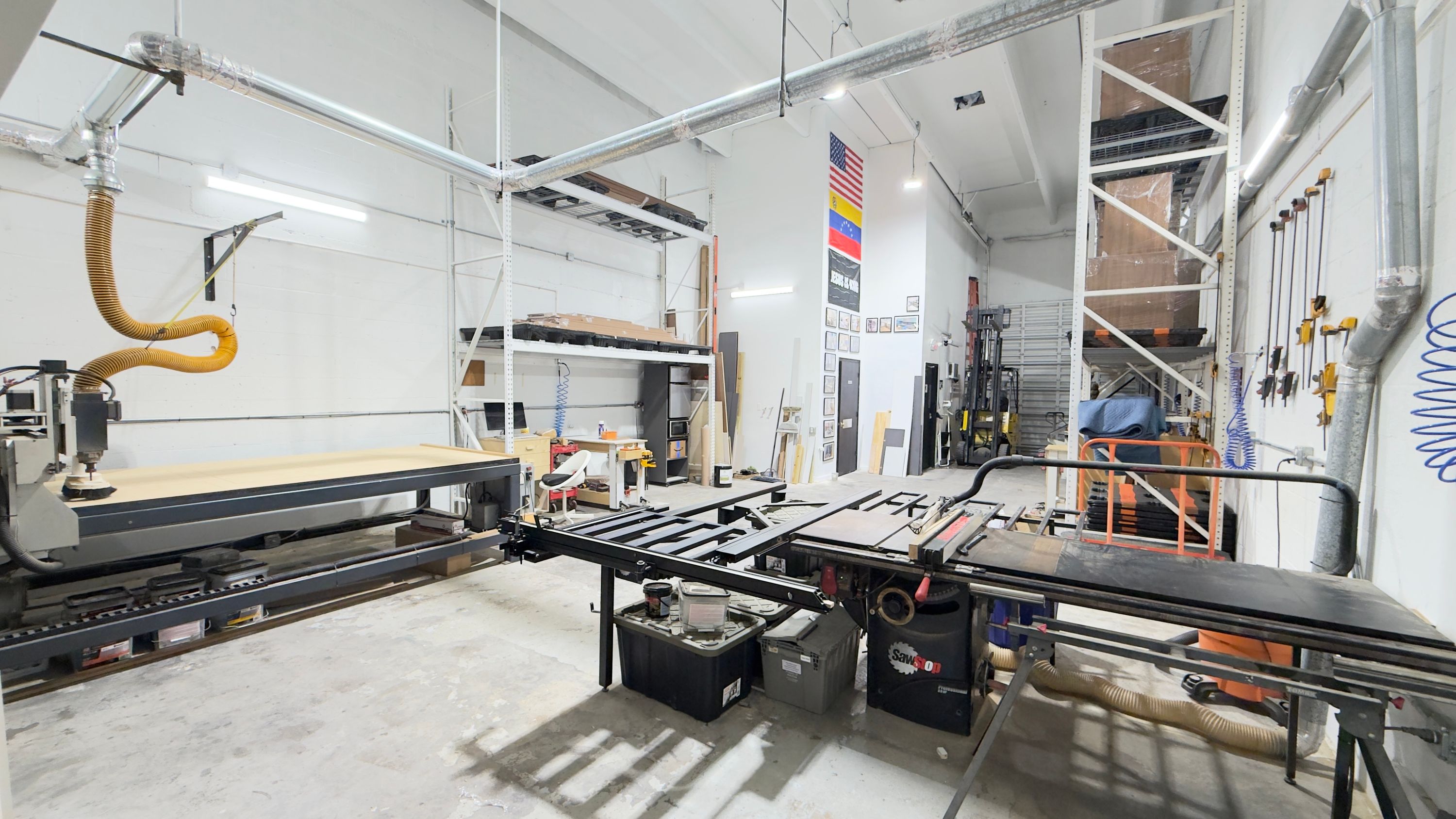 Sliding table saw and panel processing area inside the MK Design US LLC cabinet shop