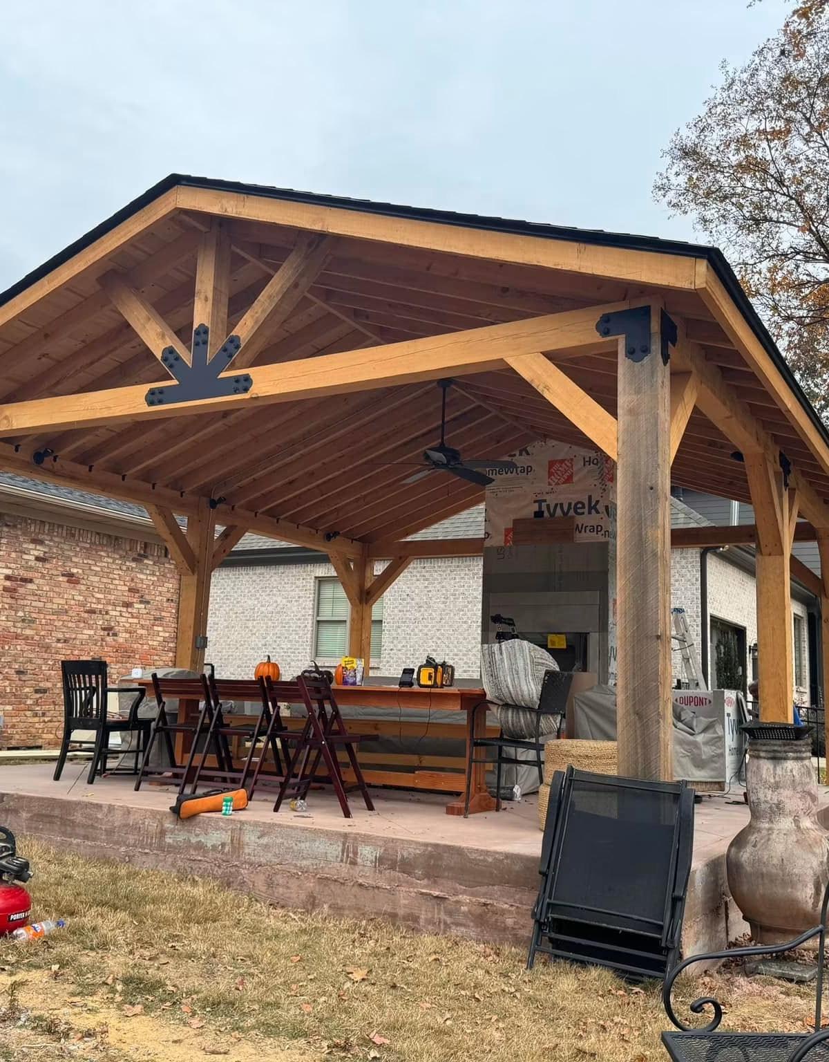 Timber-framed covered patio with a stained ceiling, built by Morales Backyard Renovations