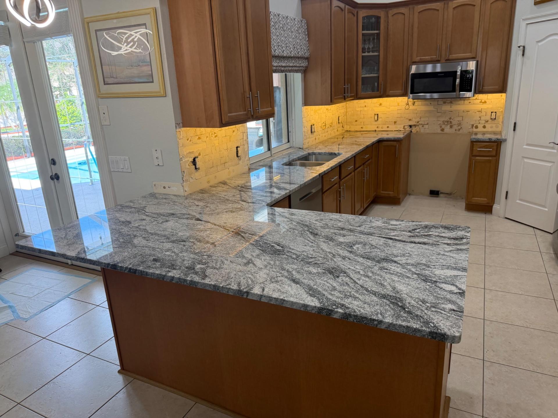 Granite kitchen countertops and peninsula installed by MVP 01 Granite