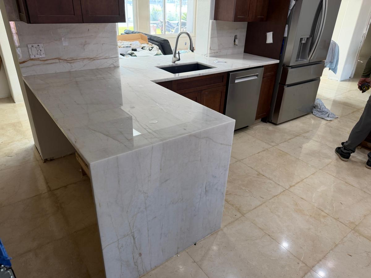 White waterfall peninsula fabricated and installed by MVP 01 Granite