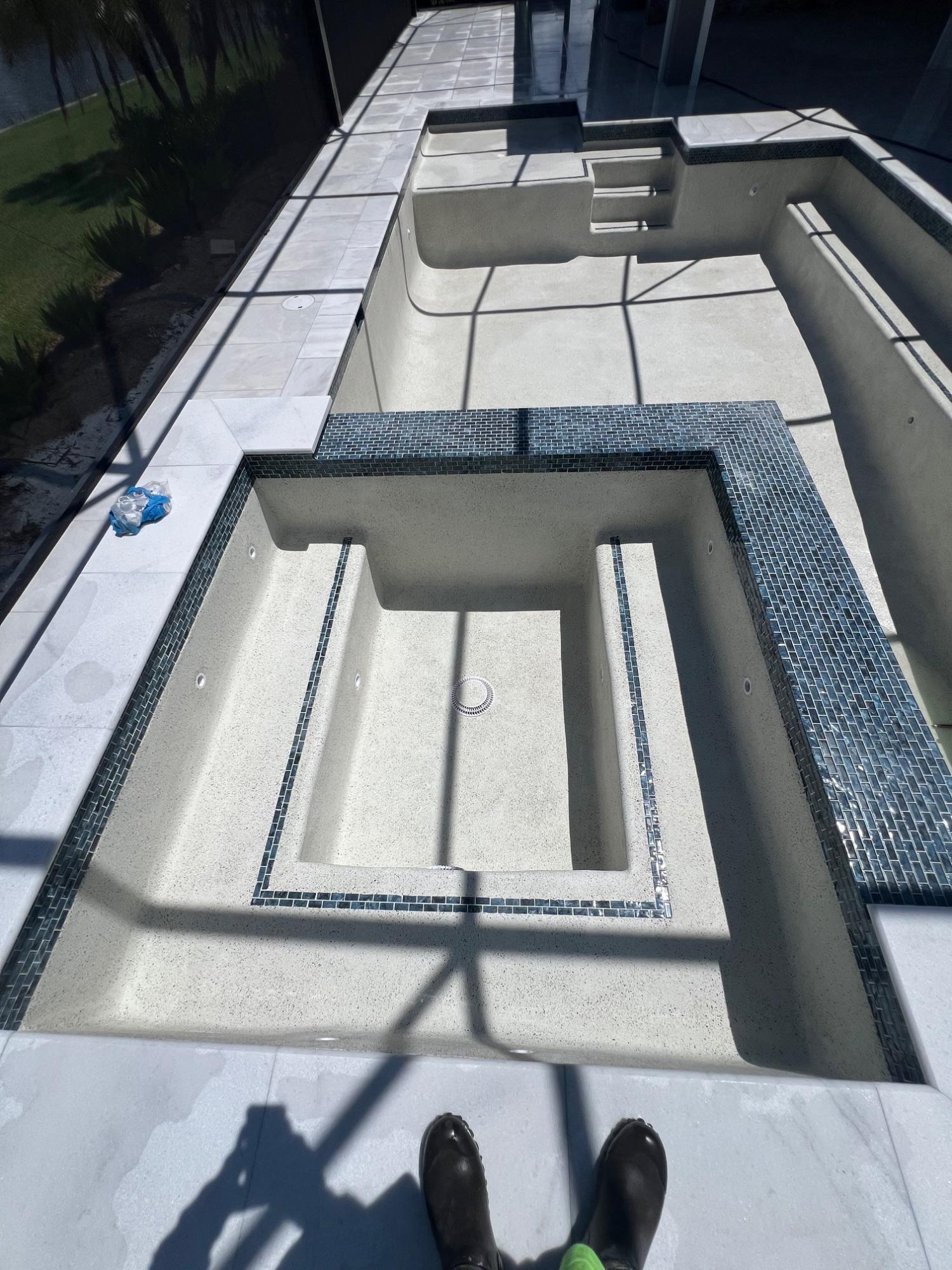 Freshly plastered pool and spa with glass-tile waterline by Oliver Finish Pool Renovation