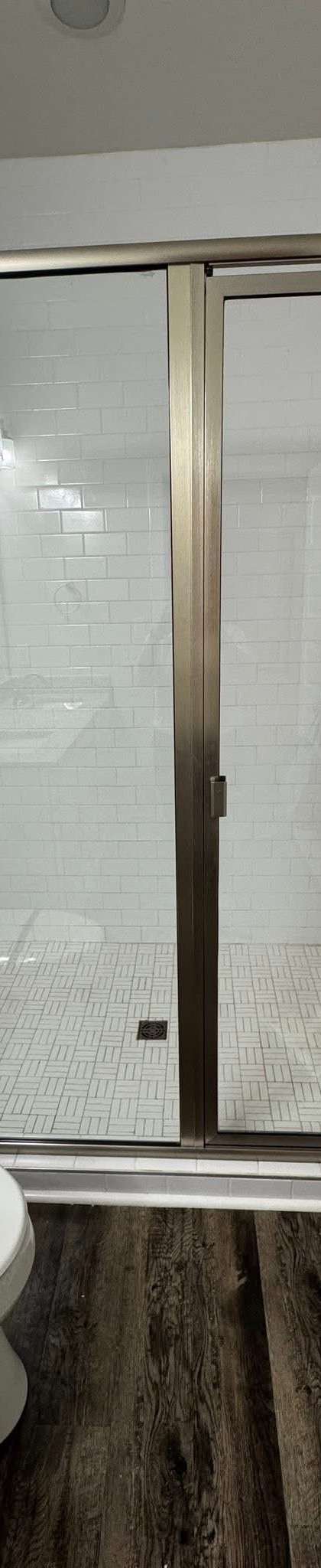 Before and after: a glass shower enclosure cleaned free of soap scum by Purple Glow Services in Murfreesboro, TN
