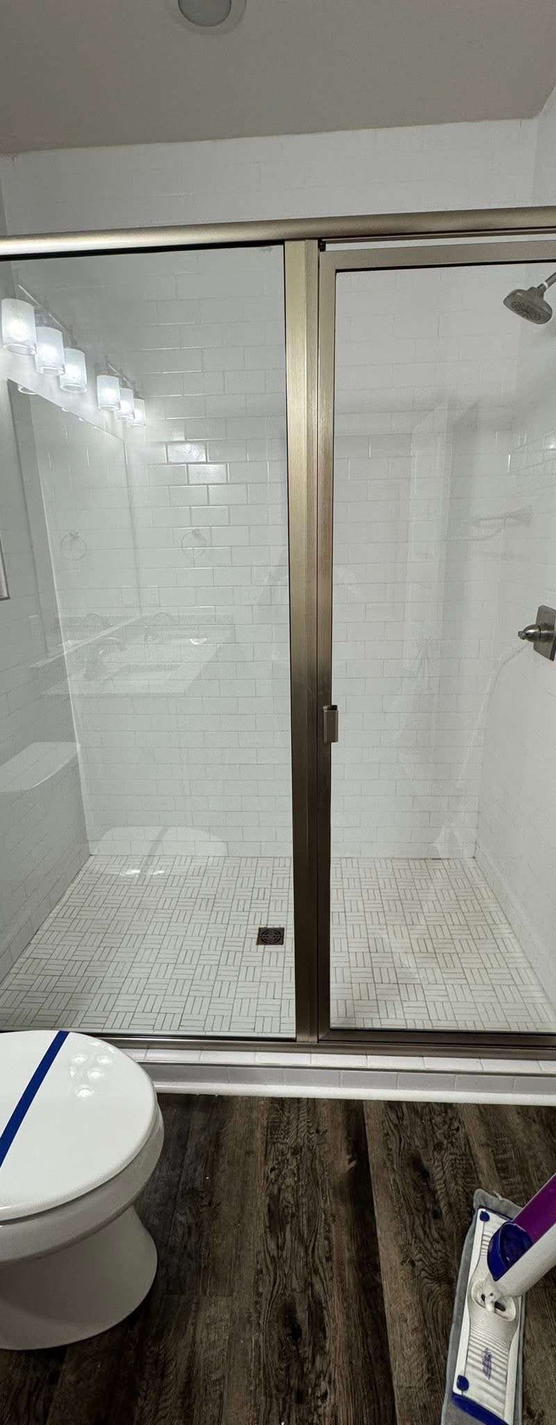 Before and after: a glass shower enclosure cleaned free of soap scum by Purple Glow Services in Murfreesboro, TN