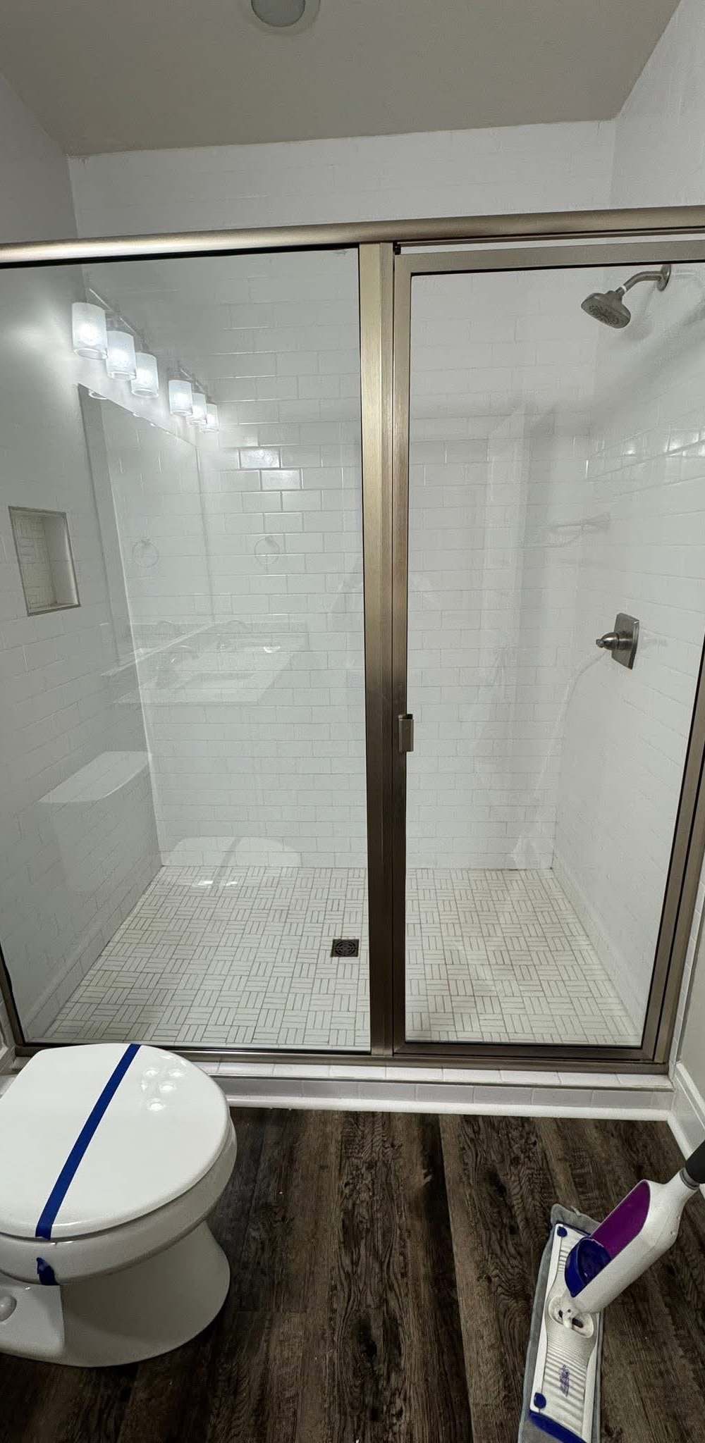 Before and after: a glass shower enclosure cleaned free of soap scum by Purple Glow Services in Murfreesboro, TN