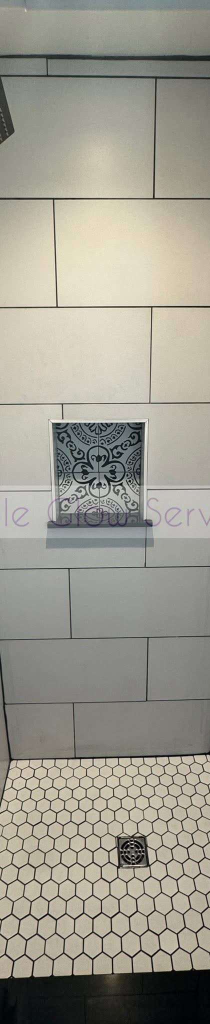 Freshly cleaned tiled walk-in shower with a hex tile floor and built-in niche in Murfreesboro, TN