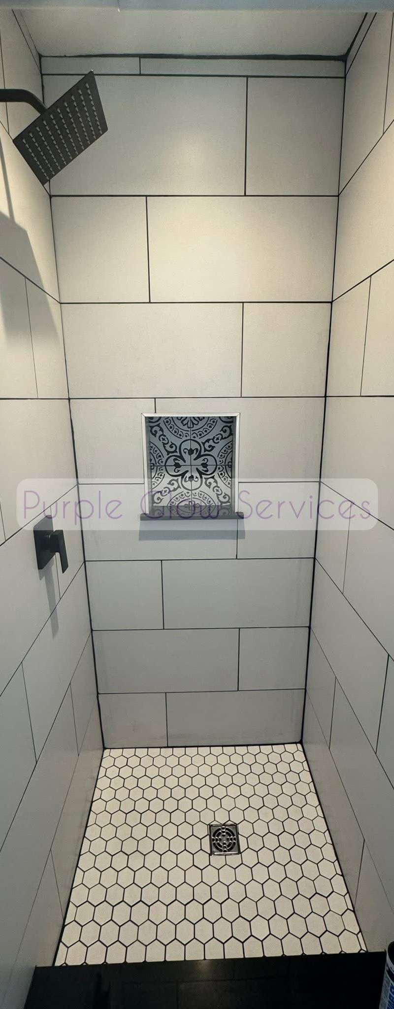 Freshly cleaned tiled walk-in shower with a hex tile floor and built-in niche in Murfreesboro, TN