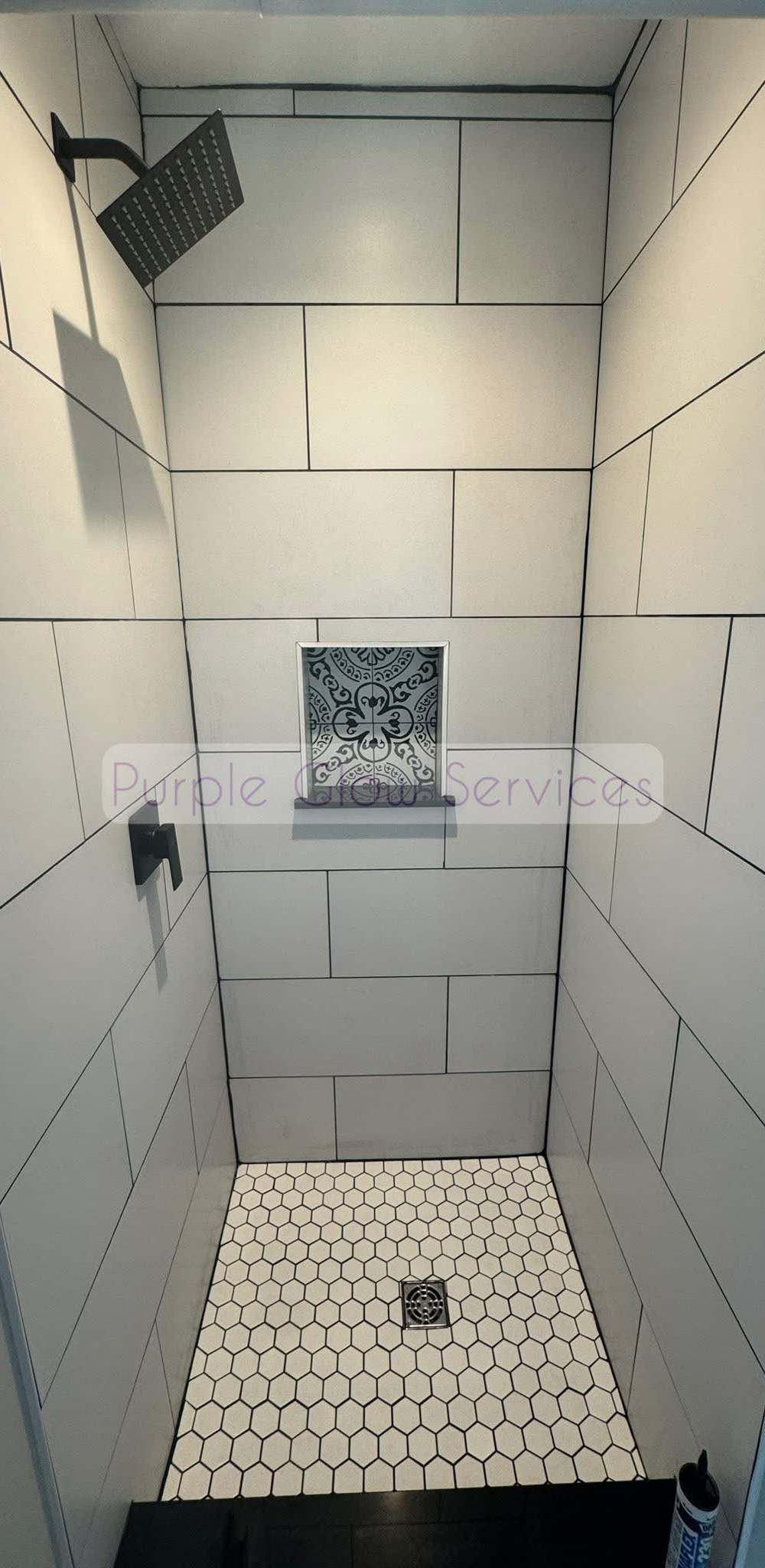 Freshly cleaned tiled walk-in shower with a hex tile floor and built-in niche in Murfreesboro, TN