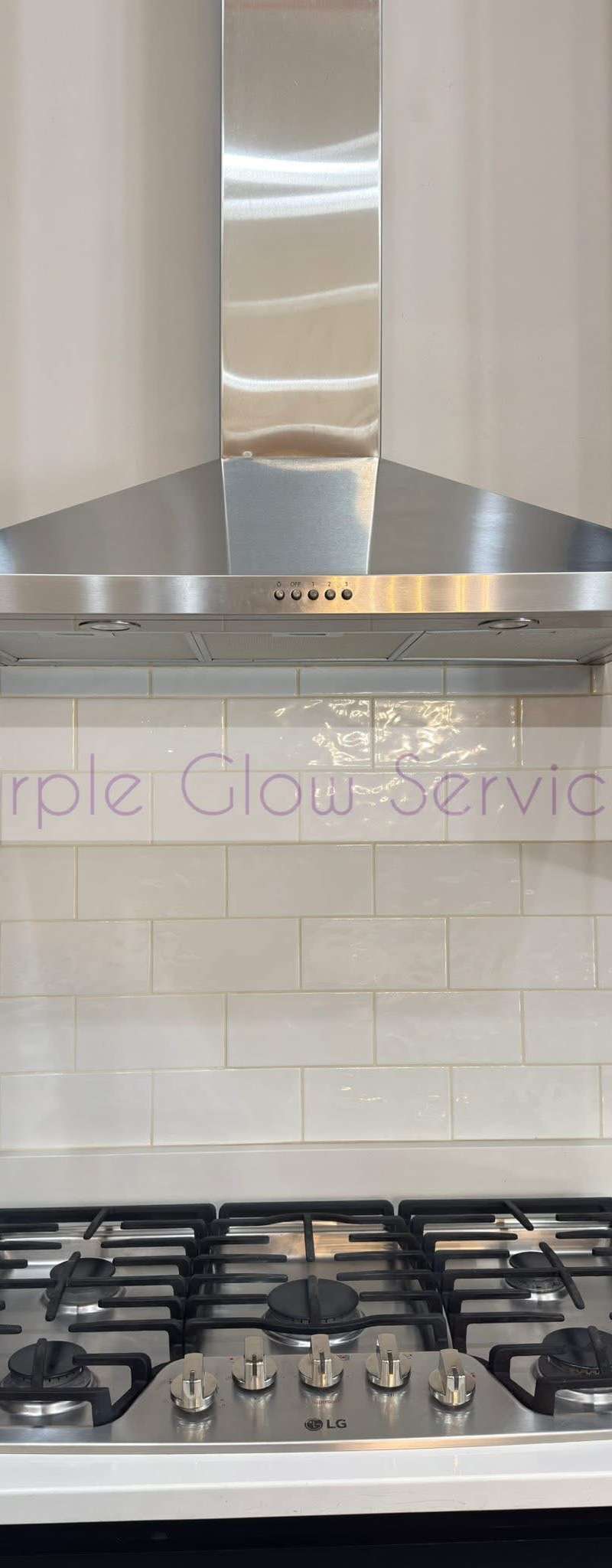 Stainless range hood, gas cooktop and white tile backsplash wiped down after a kitchen cleaning in Murfreesboro, TN