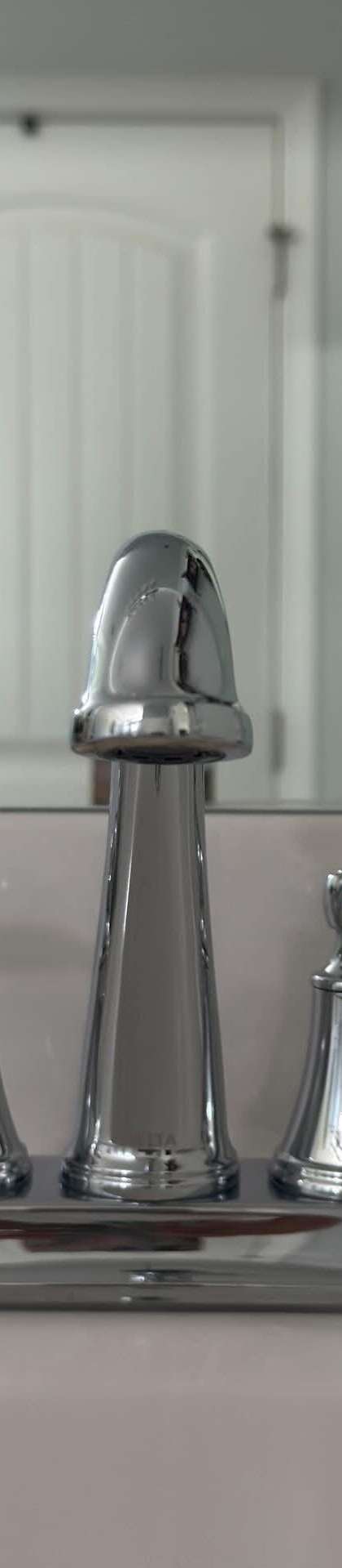 Polished chrome bathroom faucet on a spotless white vanity after a residential cleaning in Murfreesboro, TN