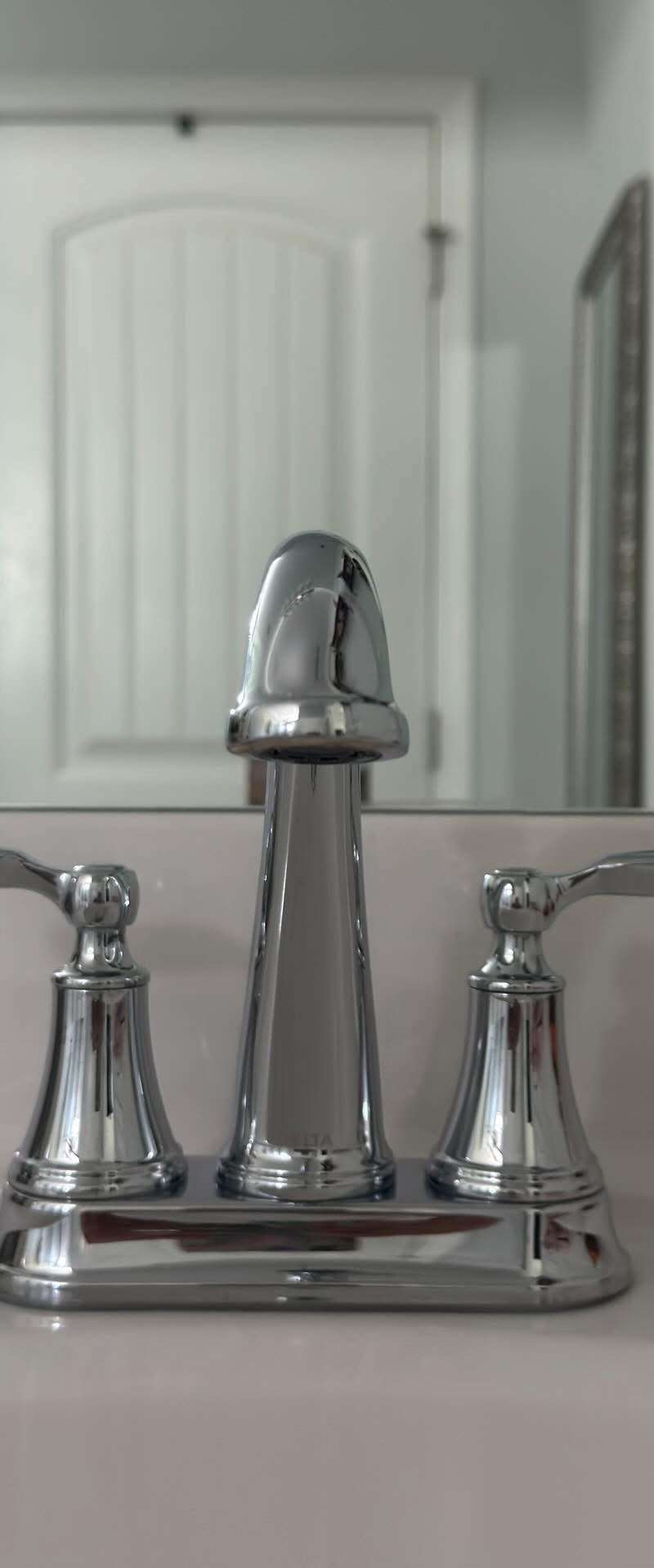 Polished chrome bathroom faucet on a spotless white vanity after a residential cleaning in Murfreesboro, TN