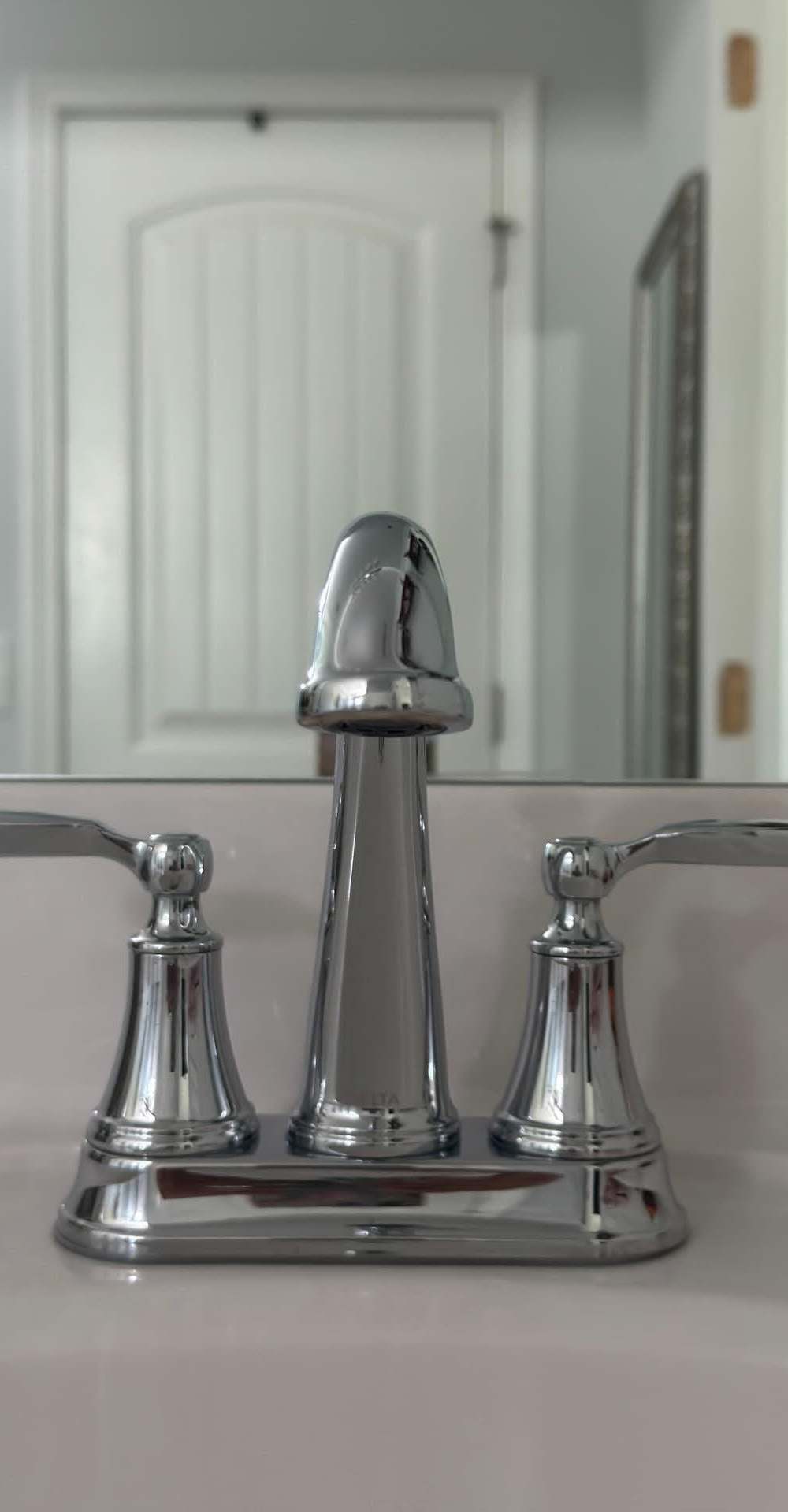Polished chrome bathroom faucet on a spotless white vanity after a residential cleaning in Murfreesboro, TN