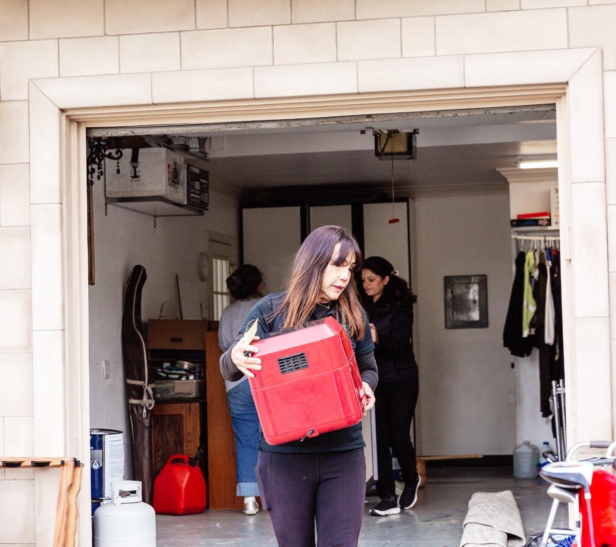A Restart Organizing organizer carrying items out during a garage reset