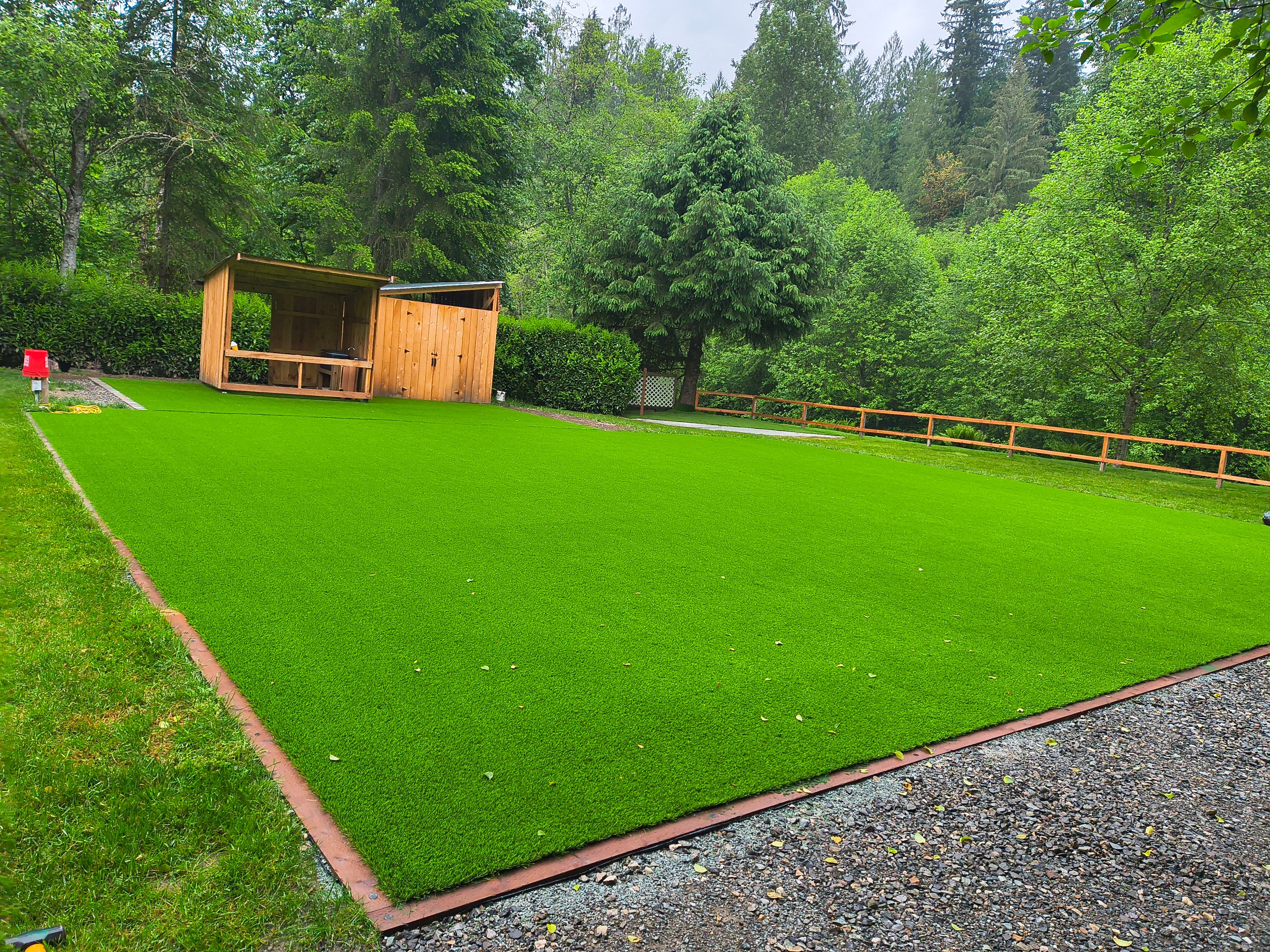 Lush green lawn maintained around a backyard shelter