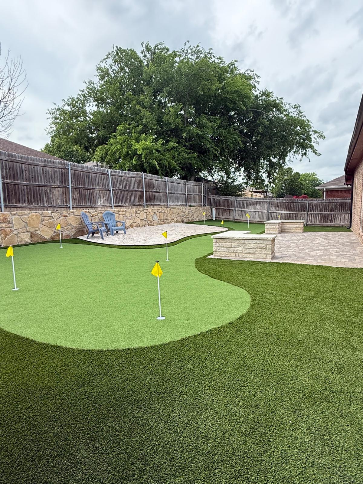 Backyard putting green and paver patio built by Txtop Hardscaping