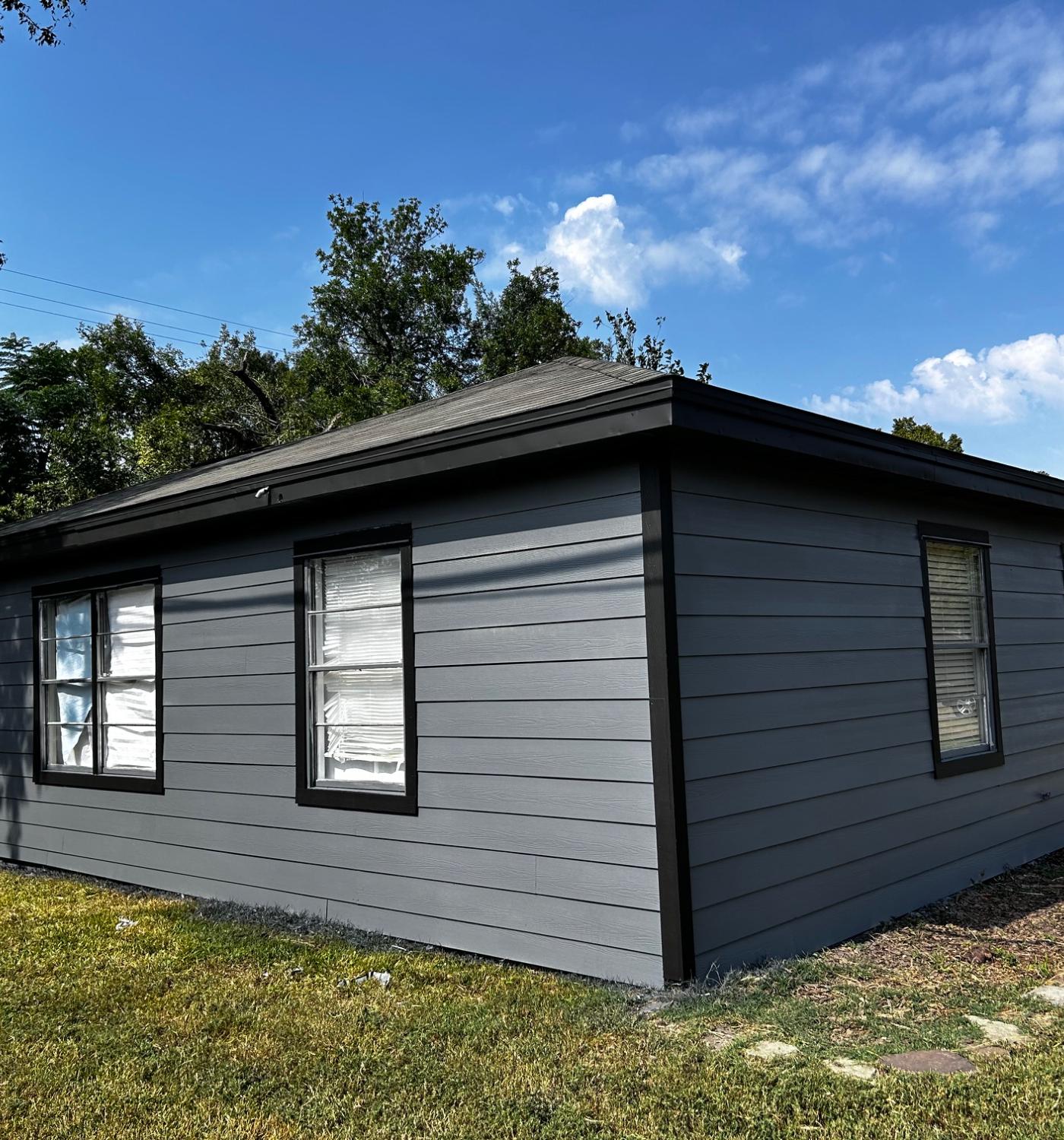 Exterior repaint — siding repaired, scraped, primed, and finished — after