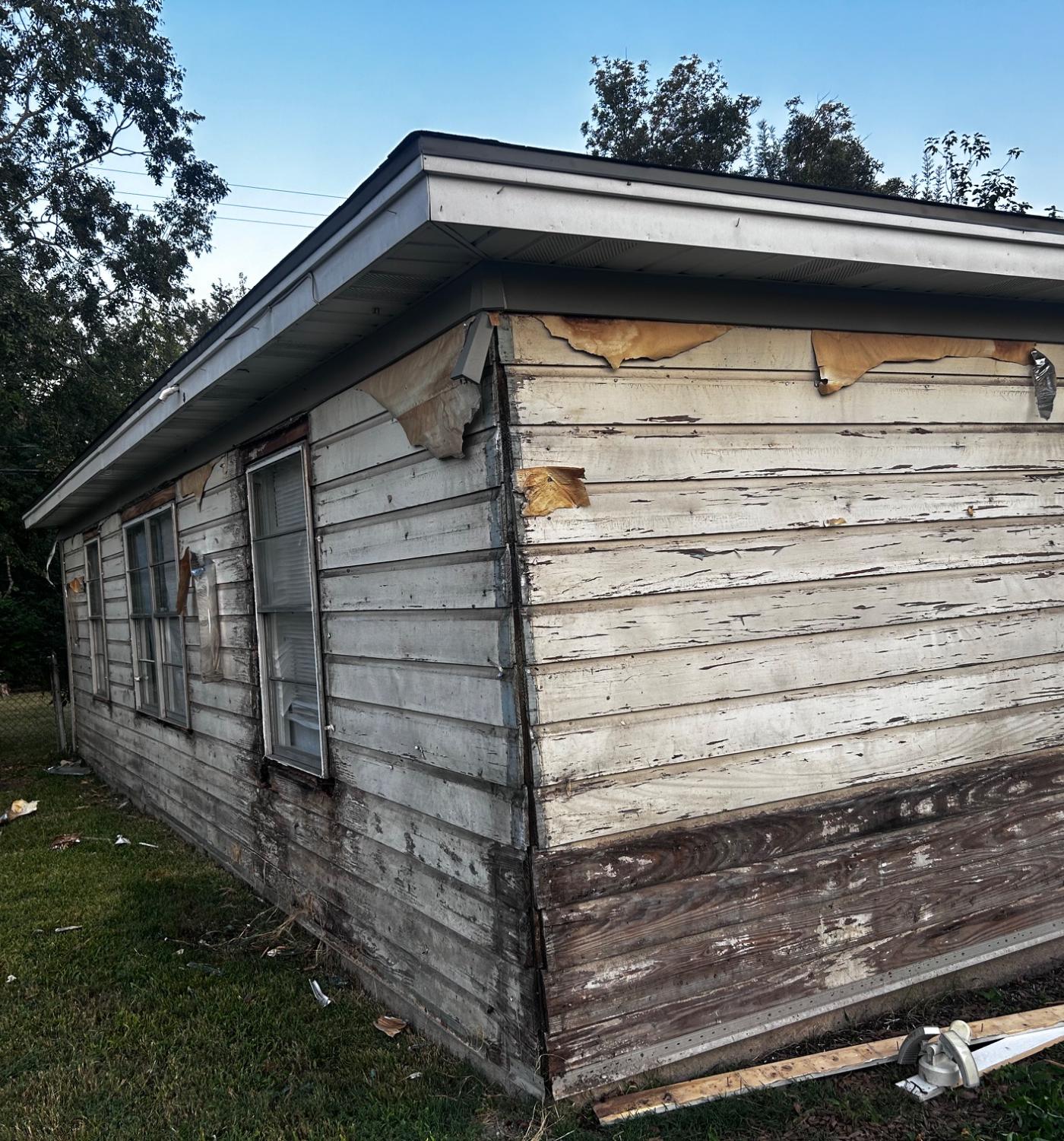 Exterior repaint — siding repaired, scraped, primed, and finished — before