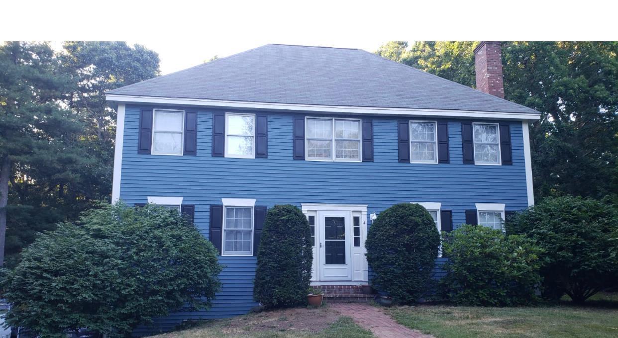 Blue colonial home with fresh exterior paint and black shutters, painted by WB Painting & Cleaning Inc.