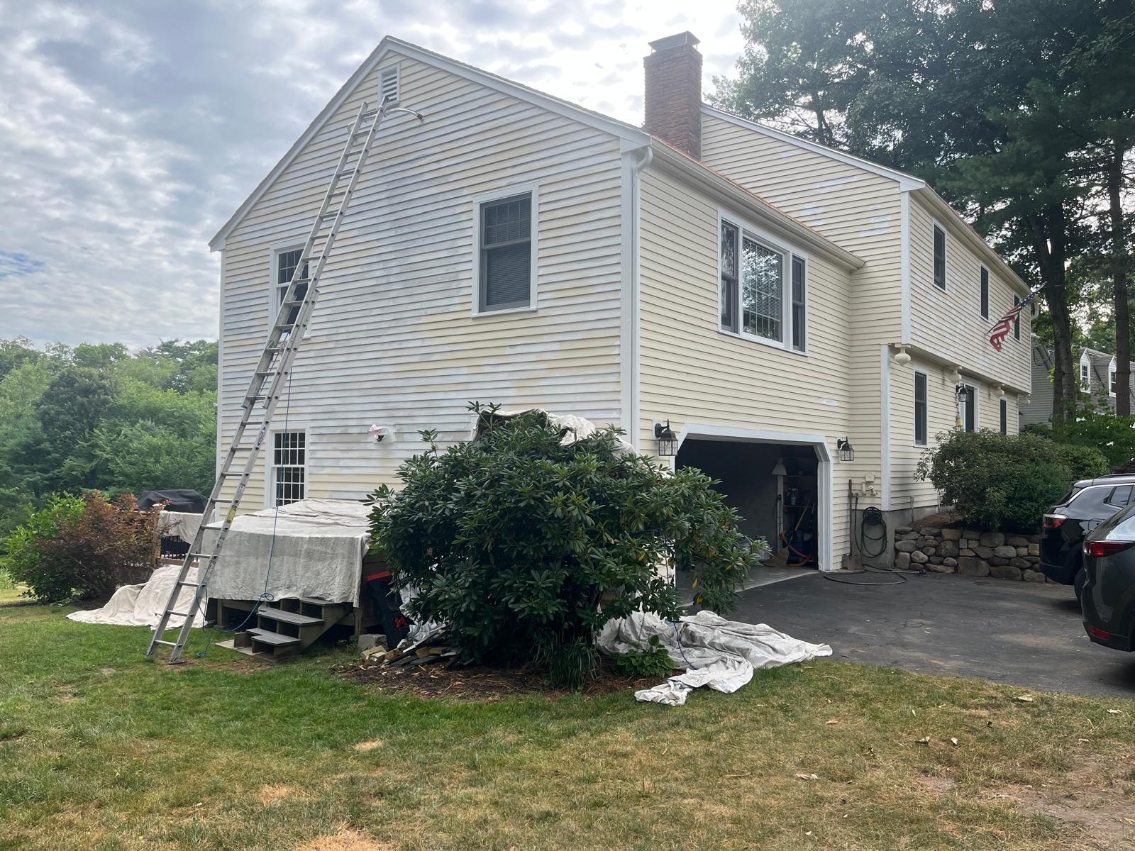 Clapboard siding, scraped, primed, and repainted — before