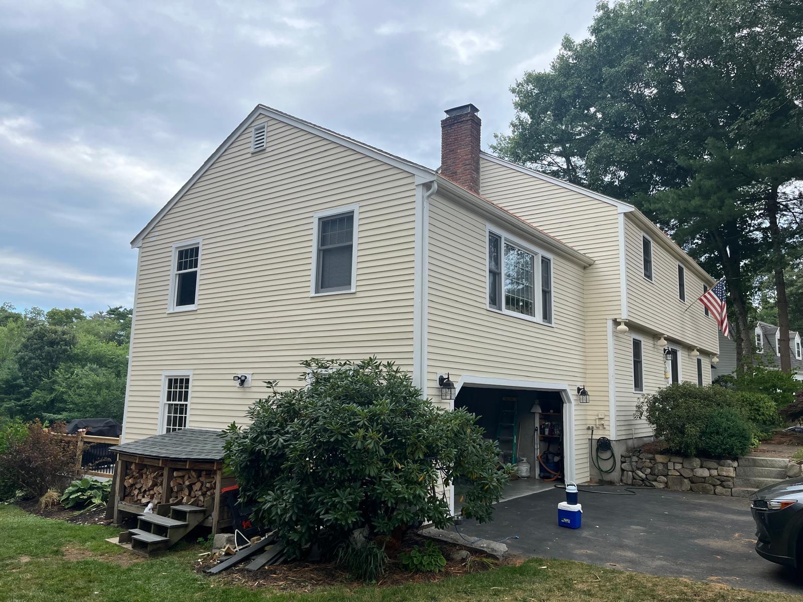Clapboard siding, scraped, primed, and repainted — after